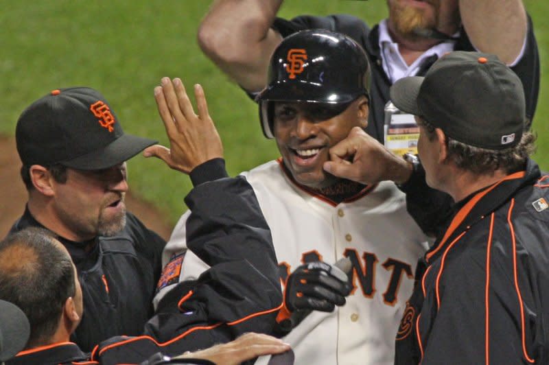 San Francisco Giants Barry Bonds is mobbed by teammates after hitting his 756th career home run, passing Hank Aaron for the all-time home run record against the Washington Nationals at AT&T Park in San Francisco on August 7, 2007. File Photo by Terry Schmitt/UPI