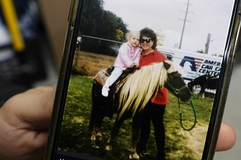 Lisa Hohnstreiter holds a cell phone displaying a photograph of herself and her mother, Nancy Harrison, in Warren, Mich., on Friday, Nov. 24, 2023. Not long after DeAngelo Martin was released from jail, he killed for the second time. On March 19, 2019, the body of Nancy Harrison, 52, was discovered in an abandoned house on Coventry Street. (AP Photo/Carlos Osorio)