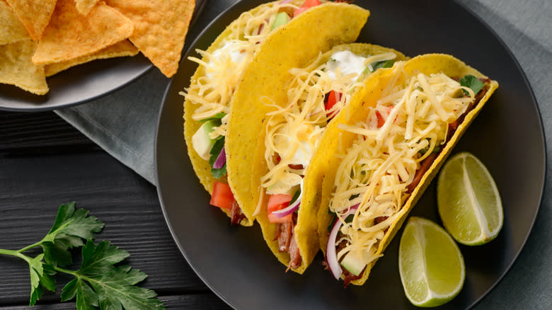 Hard tacos and limes on plate