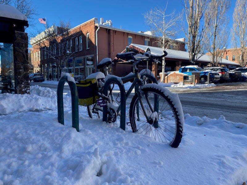 Snow covers a bike parked in Flagstaff on Dec. 12, 2022.