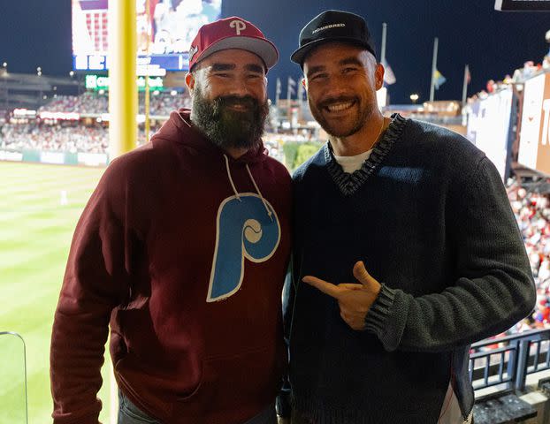 <p>Gabriella Ricciardi/MLB Photos via Getty</p> Jason and Travis Kelce attend game 1 of the NLCS between the Arizona Diamondbacks and the Philadelphia Phillies