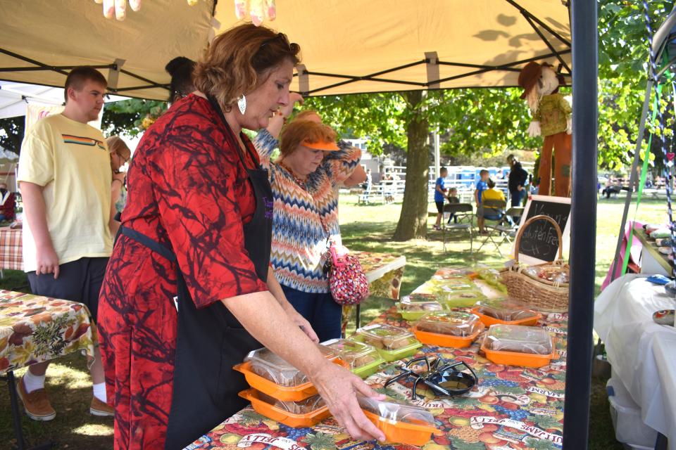 Jane Spence of Tecumseh is pictured at her Momma's Sweet Treats booth at the 2021 Clinton Fall Festival. She'll be one of the vendors at the 2022 festival, which is Sept. 23-25.