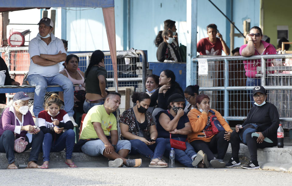 Relatives of prisoners await news outside the Litoral Penitentiary in Guayaquil, Ecuador, Wednesday, September 29, 2021. The authorities report at least 100 dead and 52 injured during a riot on Tuesday at the prison. (AP Photo/Angel DeJesus)