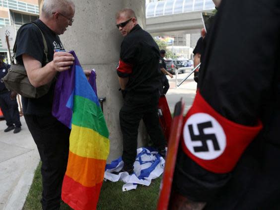 National Socialist Movement member appears to urinate on Israeli flag (REUTERS)