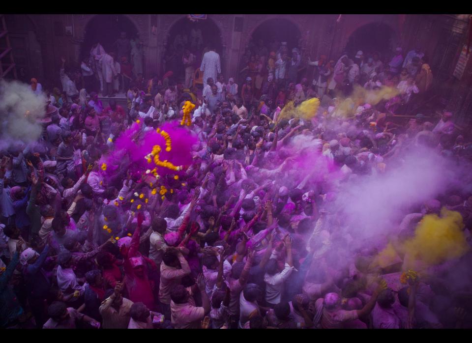 Hindu devotees play with coloured powders during Holi celebrations at the Bankey Bihari Temple in Vrindavan, India.&nbsp;