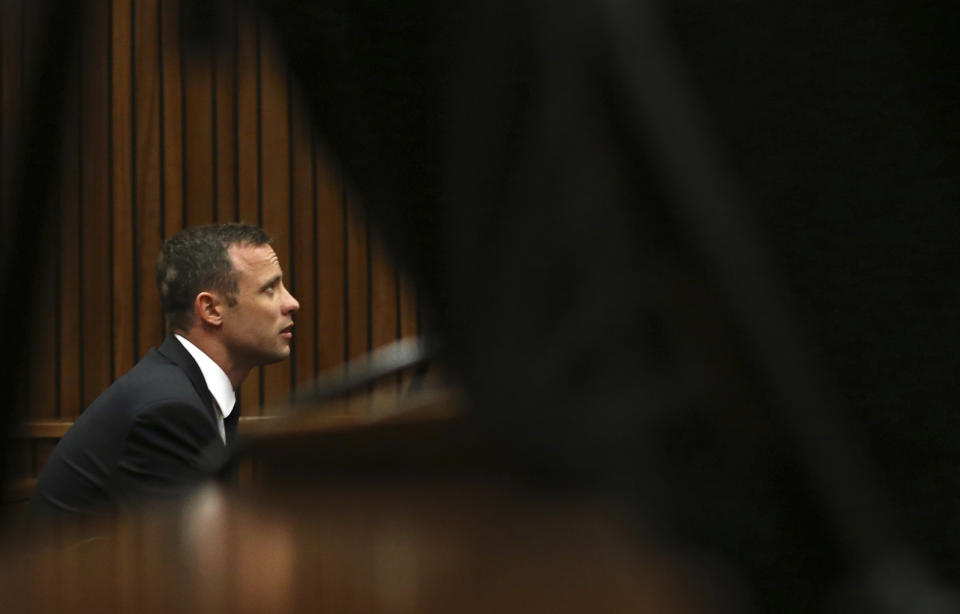 Oscar Pistorius sits in the dock while listening to ballistic evidence being given in court in Pretoria, South Africa, Wednesday, March 19, 2014. Pistorius is on trial for the murder of his girlfriend Reeva Steenkamp on Valentine's Day in 2013. (AP Photo/Themba Hadebe, Pool)