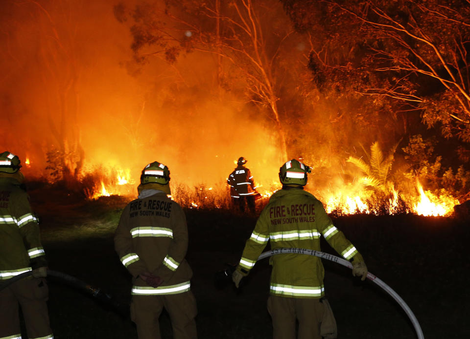 Fire crews undertake back burning near Railway Crescent, Belmont, Lake Macquarie, NSW on Thursday. NSW Rural Fire Service has issued an emergency warning for an out-of-control bushfire burning in Lake Macquarie. Source: AAP Image/Darren Pateman