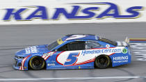 Kyle Larson (5) heads toward Turn 1 during a NASCAR Cup Series auto race at Kansas Speedway in Kansas City, Kan., Sunday, Oct. 24, 2021. (AP Photo/Colin E. Braley)