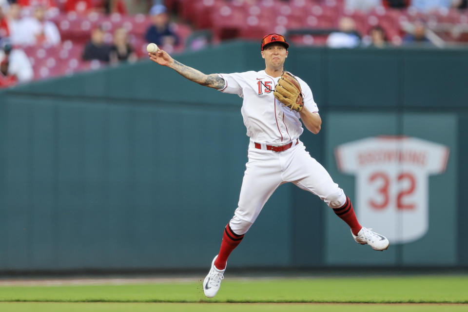 Cincinnati Reds' Nick Senzel throws to first on a ball hit by Tampa Bay Rays' Manuel Margot, who was safe during the fifth inning of a baseball game in Cincinnati, Tuesday, April 18, 2023. (AP Photo/Aaron Doster)