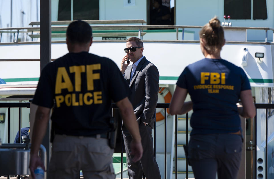 FILE - In this Sept. 8, 2019 file photo, investigators check the Truth Aquatics office on the Santa Barbara Harbor in Santa Barbara, Calif. Authorities conducting a criminal investigation into the deadly scuba diving boat fire off the coast of Southern California last week plan to interview previous patrons of the boat company to determine what kind of safety information they were provided during trips, a law enforcement source said. (AP Photo/Christian Monterrosa, File)