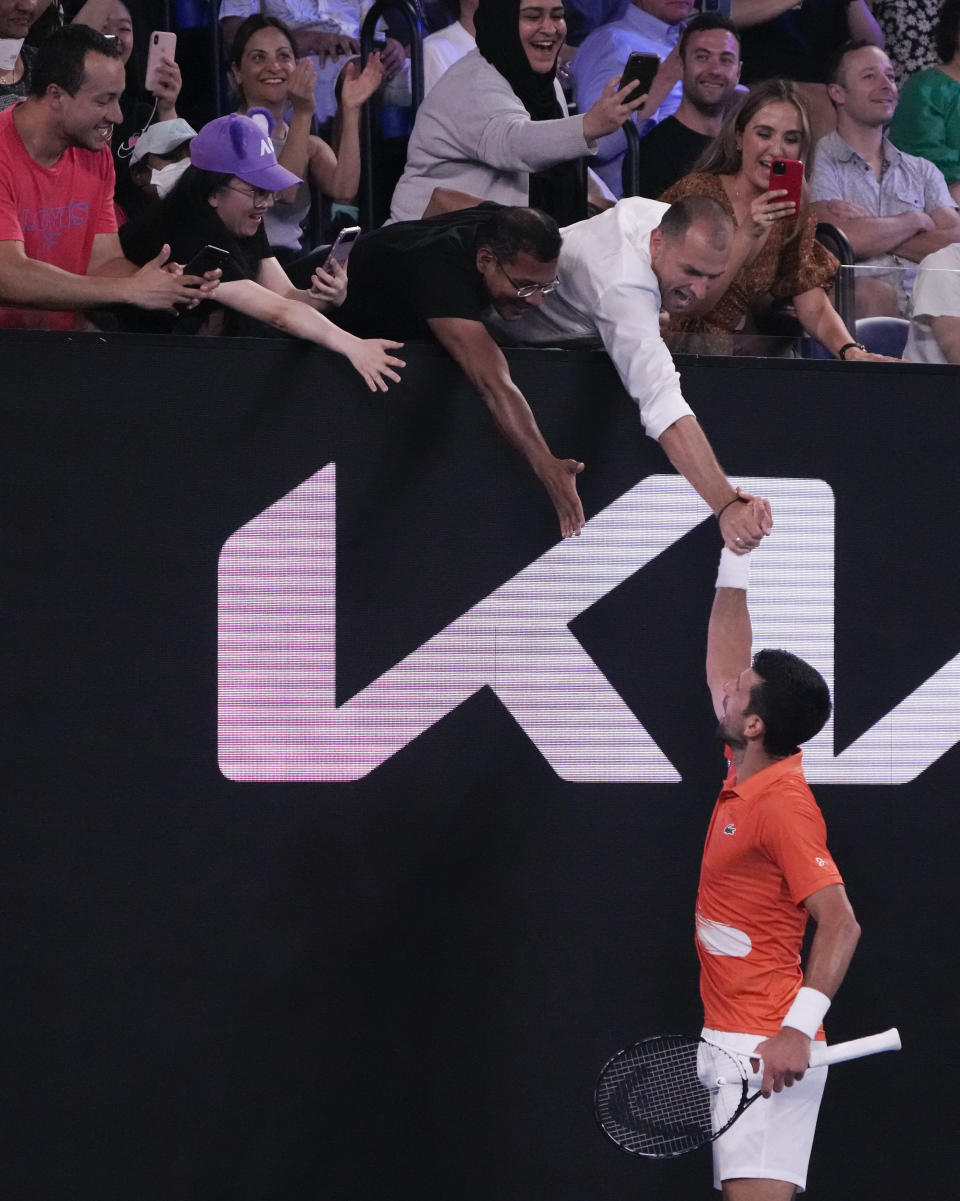 Serbia's Novak Djokovic reacts with spectators during an exhibition match against Australia's Nick Kyrgios on Rod Laver Arena ahead of the Australian Open tennis championship in Melbourne, Australia, Friday, Jan. 13, 2023. (AP Photo/Mark Baker)