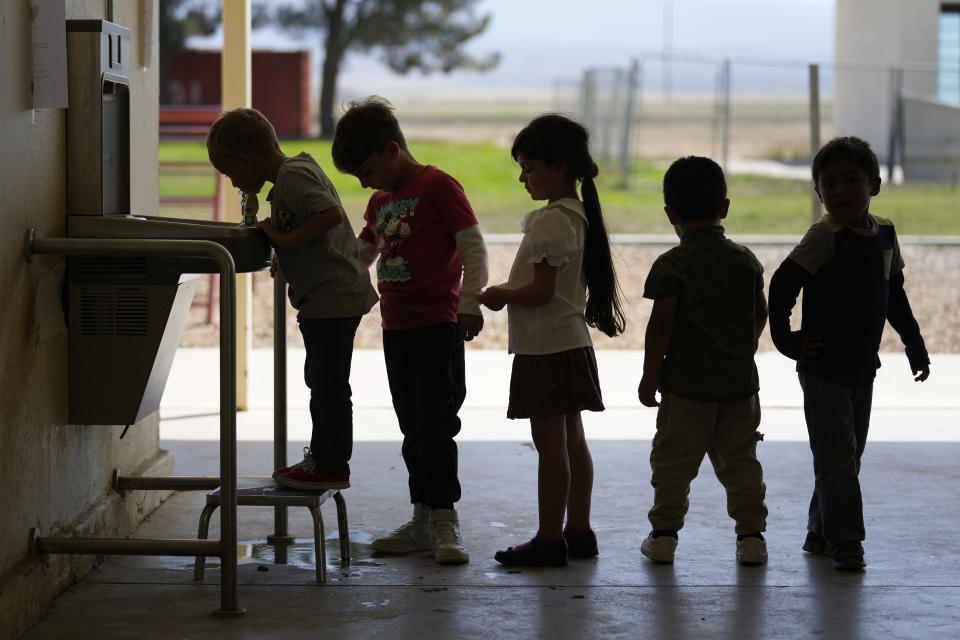 Children line up to drink water from a fountain inside Cuyama Elementary School, Wednesday, Sept. 20, 2023, in New Cuyama, Calif. (AP Photo/Marcio Jose Sanchez)