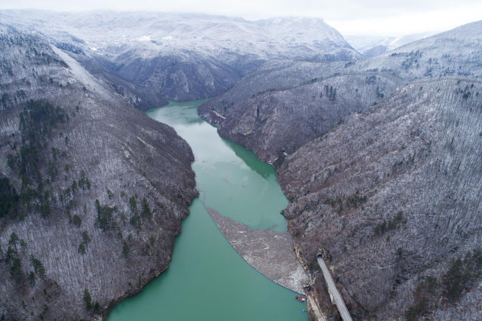 Aerial view of waste floating in the Drina river near Visegrad, Bosnia, Wednesday, Jan. 10, 2024. Tons of waste dumped in poorly regulated riverside landfills or directly into the rivers across three Western Balkan countries end up accumulating during high water season in winter and spring, behind a trash barrier in the Drina River in eastern Bosnia. (AP Photo/Armin Durgut)