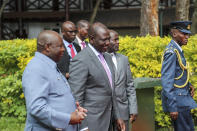 Kenya's President William Ruto, center, and Burundi's President and summit chairperson Evariste Ndayishimiye, left, arrive for the Third Inter-Congolese Consultations of the Nairobi Peace Process, the political track, Nairobi III, at a hotel in Nairobi, Kenya Monday, Nov. 28, 2022. The East African Community (EAC) led summit aims to find solutions to the ongoing armed conflict in Eastern Congo. (AP Photo/Brian Inganga)