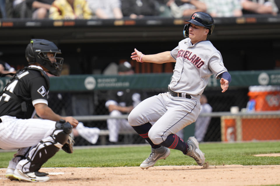 CORRECTS THAT ROCCHIO REACHED ON AN ERROR, NOT A SINGLE - Cleveland Guardians' Will Brennan slides into home past Chicago White Sox catcher Seby Zavala as he scores on a ball hit by Brayan Rocchio, who reached on an error during the seventh inning of a baseball game, Thursday, May 18, 2023, in Chicago. (AP Photo/Erin Hooley)
