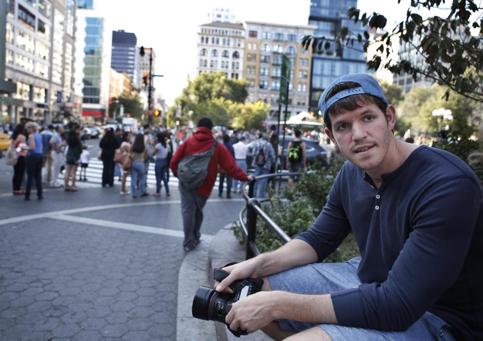 This Oct. 2, 2013 photo shows street portrait photographer Brandon Stanton, creator of the popular Humans of New York blog, near Union Square in New York. Stanton’s magical blend of portraits and poignant, pithy storytelling has earned HONY more than 2 million followers online. Now he’s putting his work in a book, “Humans of New York,” due out Oct. 15 from St. Martin’s Press. (AP Photo/Kathy Willens)