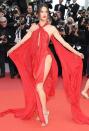 Alessandra makes the <em>Les Misérables </em>red carpet her catwalk in a Julien Macdonald scarlet red silk chiffon halter dress with ultra-high slit and dramatic cape.