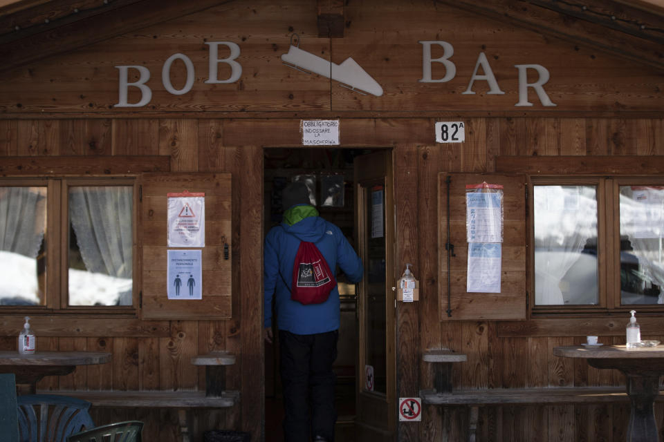 A view of the Bob bar in Cortina d'Ampezzo, Italy, Wednesday, Feb. 17, 2021. When Cortina's century-old bobsled track closed for financial reasons 13 years ago, the adjacent coffee bar kept on serving espressos. Bar owner Costantini pines for the good old days when drivers and brakemen would come whizzing down the track on one side of the café and then hop off their sleds on the other side and come in for a shot of espresso, a vin brulé or perhaps even a taste of the local grappa. (AP Photo/Gabriele Facciotti)