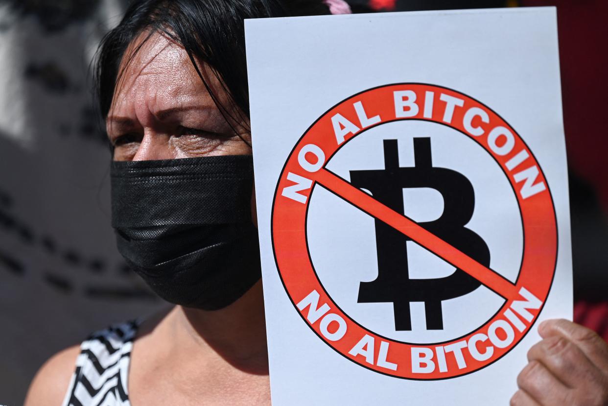 A woman holds a banner that reads 