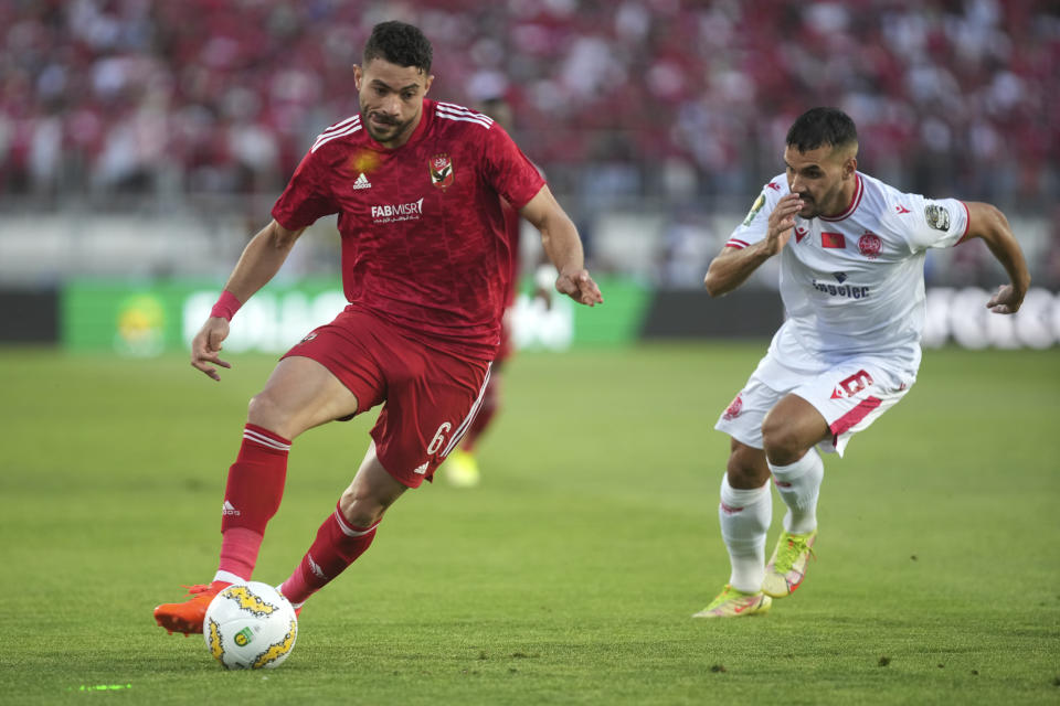 Al Ahly's Yasser Ibrahim, left, challenges for the ball with Wydad's Jalal Daoudi during the CAF Champions League Soccer final soccer match between Morocco's Wydad Athletic Club and Egypt's Al Ahly SC, at the Mohammed V stadium, in Casablanca, Morocco, Sunday, June 11, 2023. (AP Photo/Mosa'ab Elshamy)