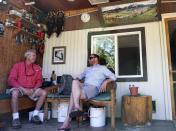 In this July 6, 2019, photo Fish Creek Mobile Home Park resident Jeff Morehead, left, visits with Yampa Valley Housing Authority Executive Director Jason Peasley in Steamboat Springs, Colo. Some Colorado towns are taking action to preserve their remaining mobile home parks. Cities, counties and housing authorities, such as the Yampa Valley Housing Authority in Steamboat Springs, are buying mobile home parks to preserve affordable housing for residents as other mom-and-pop park owners sell out to developers or investors. (Matt Stensland/The Colorado Sun via AP)