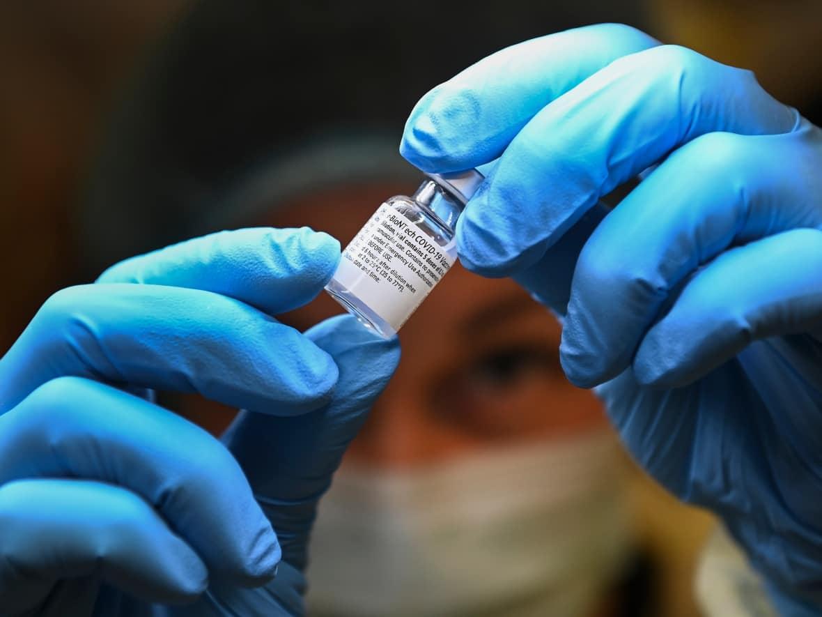 A health-care worker prepares a dose of the Pfizer-BioNTech COVID-19 vaccine at a COVID-19 vaccine clinic in Toronto on Thursday, Jan. 7, 2021. Twenty-two of the 26 new COVID-19 cases announced Wednesday in Nova Scotia are in the central zone. (Nathan Denette/The Canadian Press - image credit)