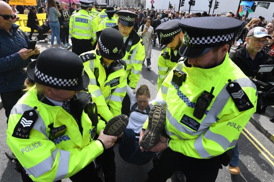 Police arrest a protester at Oxford Circus (EPA)