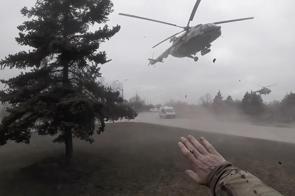 A Ukrainian medical evacuation helicopter lands in front of Yuliia Paievska, known as Taira, in Mariupol, Ukraine, on Feb. 27, 2022. Using a body camera, she recorded her team's frantic efforts to bring people back from the brink of death. (Yuliia Paievska via AP)