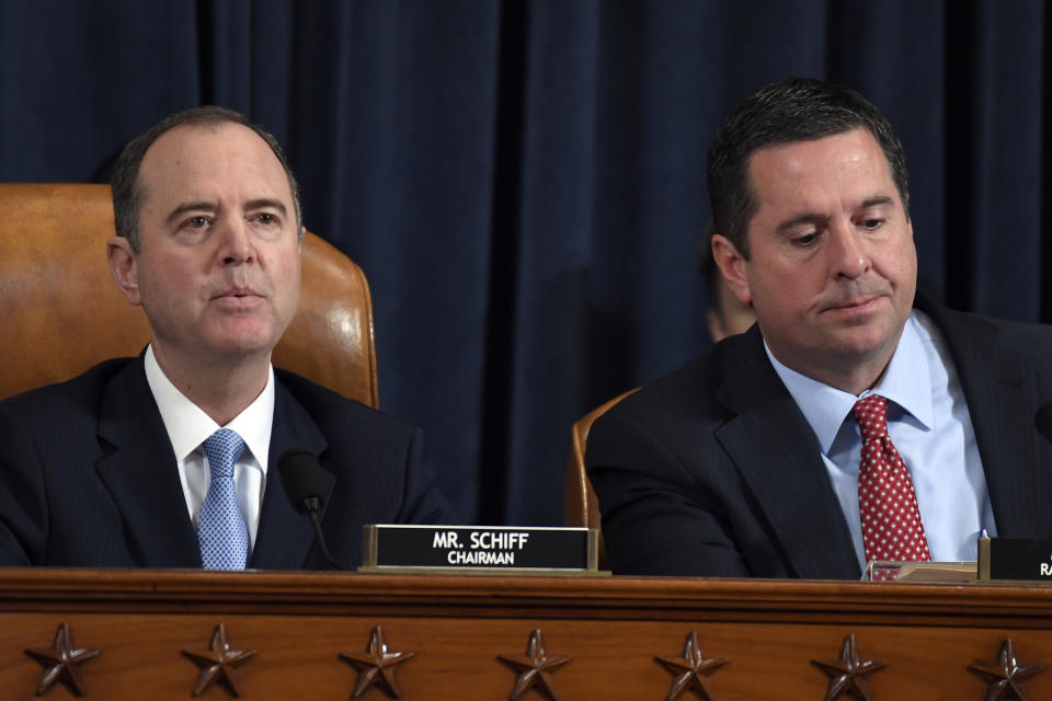 House Intelligence Committee Chairman Adam Schiff of Calif., left, speaks as Rep. Devin Nunes, R-Calif., the ranking member on the committee, listens during the House Intelligence Committee on Capitol Hill in Washington, Wednesday, Nov. 13, 2019, in the first public impeachment hearing of President Donald Trump's efforts to tie U.S. aid for Ukraine to investigations of his political opponents. (AP Photo/Susan Walsh)