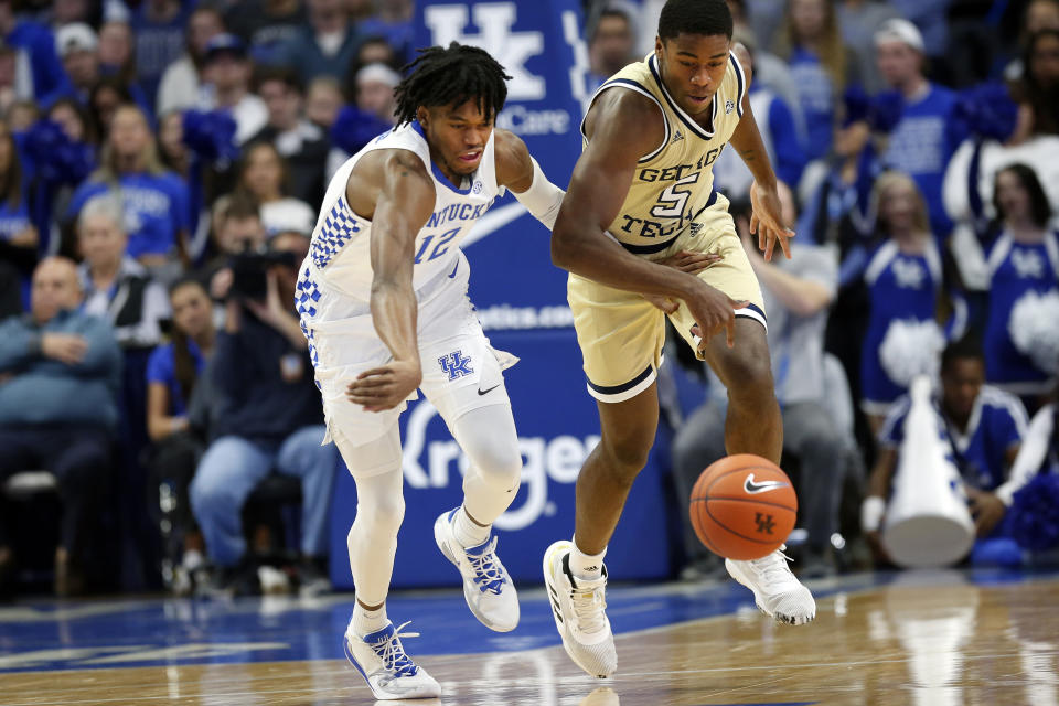 Kentucky's Keion Brooks Jr., left, and Georgia Tech's Moses Wright go after a loose ball during the first half of an NCAA college basketball game in Lexington, Ky., Saturday, Dec. 14, 2019. (AP Photo/James Crisp)