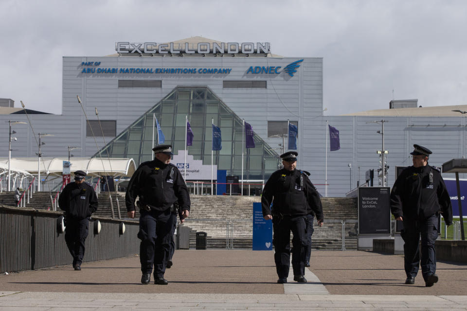 LONDON, ENGLAND - MARCH 29: Metropolitan Police officers stand outside the new NHS Nightingale Hospital at ExCeL London on March 29, 2020 in London, England. The field hospital will initially contain 500 beds with ventilators and oxygen and will have the capacity to eventually hold up to 4,000 COVID-19 patients. (Photo by Hollie Adams/Getty Images)