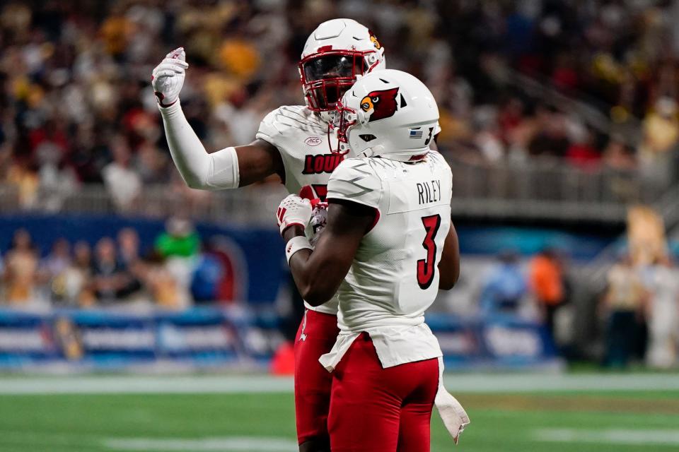 Louisville linebacker Antonio Watts (35) celebrates a stop with Louisville defensive back Quincy Riley (3) during the first half of an NCAA college football game against Georgia Tech, Friday, Sept. 1, 2023, in Atlanta. (AP Photo/Mike Stewart)
