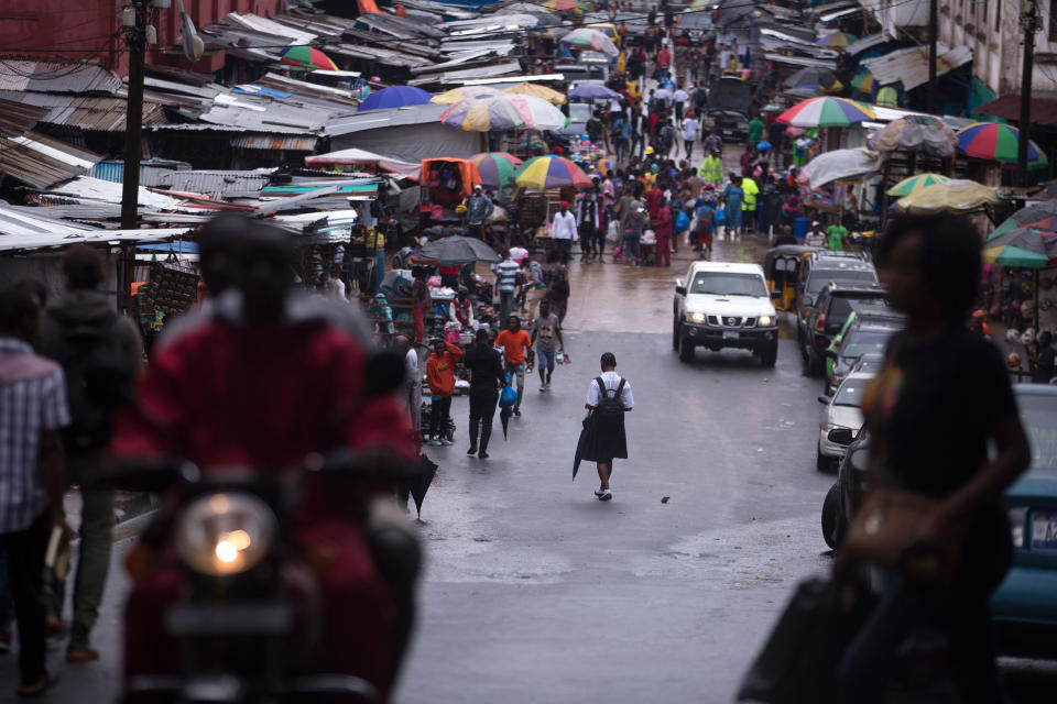 A school girl walks towards Waterside Market in Monrovia. | Kathleen Flynn, special to ProPublica