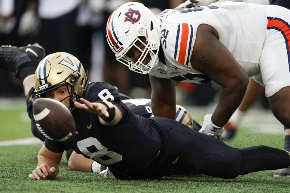 Vanderbilt quarterback Ken Seals (8) and Auburn defensive lineman Justin Rogers (52) dive for a loose ball in the second half of an NCAA college football game Saturday, Nov. 4, 2023, in Nashville, Tenn. (AP Photo/George Walker IV)