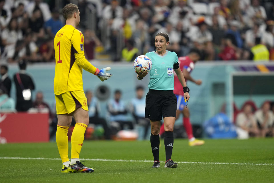Referee Stephanie Frappart, right, talks with Germany's goalkeeper Manuel Neuer during the World Cup group E soccer match between Costa Rica and Germany at the Al Bayt Stadium in Al Khor, Qatar, Thursday, Dec. 1, 2022. (AP Photo/Darko Bandic)