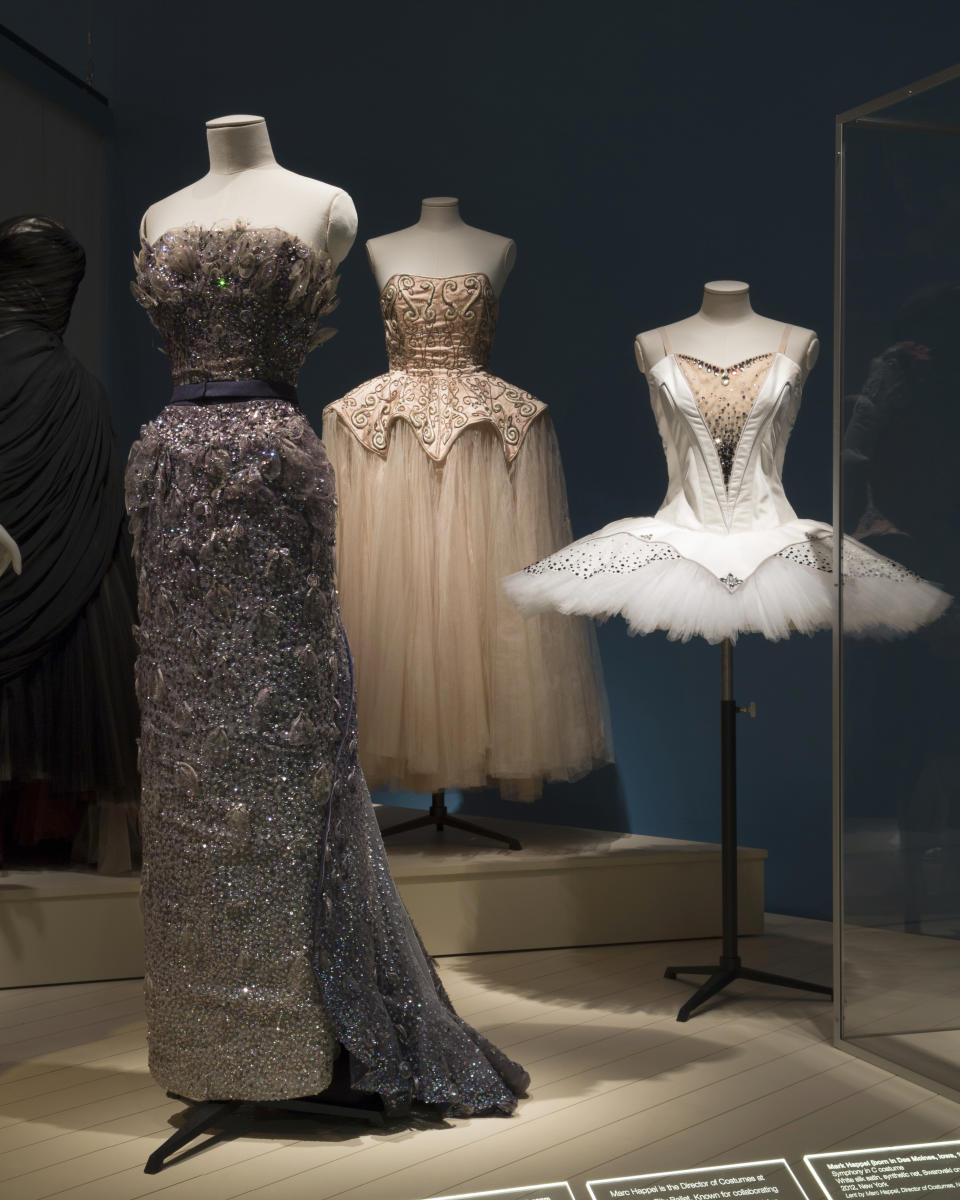This photo provided by The Museum at FIT shows a Christian Dior, “Debussy” evening gown worn by ballerina Margot Fonteyn in the spring/summer 1950; Cristobal Balenciaga for Hattie Carnegie, pink silk tulle and satin evening dress with silver metal embroidery; Marc Happel, "Symphony in C" costume, 2012, that are part of the new exhibit at the Fashion Institute of Technology in New York. The exhibit features 90 items, including ballet costumes, high fashion and athletic wear. (Eileen Costa/The Museum at FIT via AP)