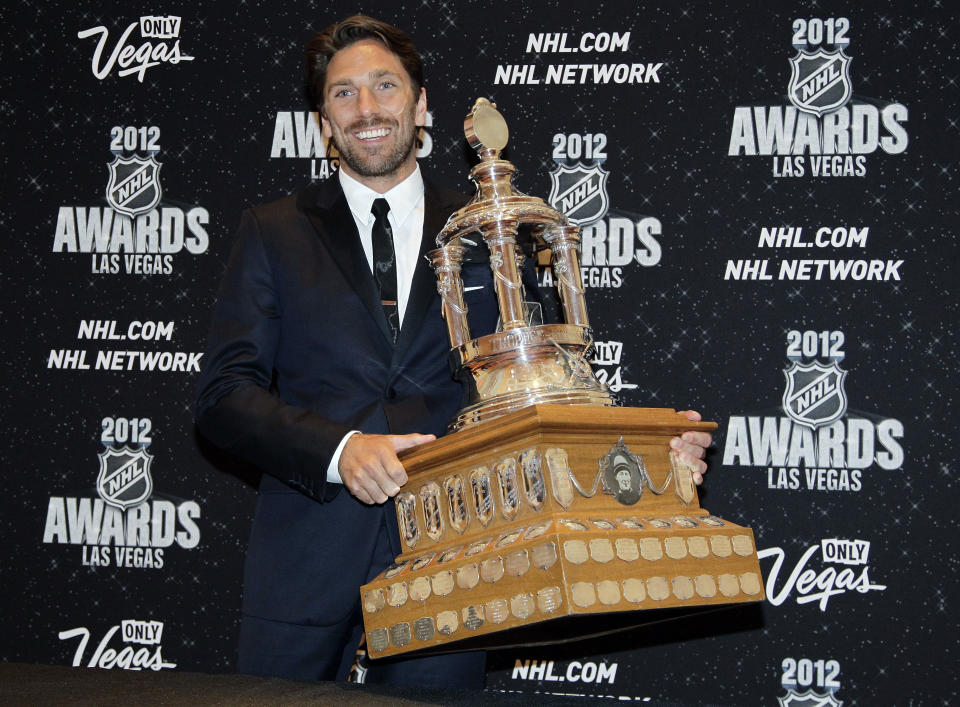 FILE - In this June 20, 2012, file photo, New York Rangers' Henrik Lundqvist poses with the Vezina Trophy after winning the award for the league's best goalie during the NHL Awards in Las Vegas. The New York Rangers have bought out the contract of star goaltender Henrik Lundqvist. The Rangers parted with one of the greatest netminders in franchise history on Wednesday, Sept. 30, 2020, when they paid off the final year of his contract.(AP Photo/Julie Jacobson, File)