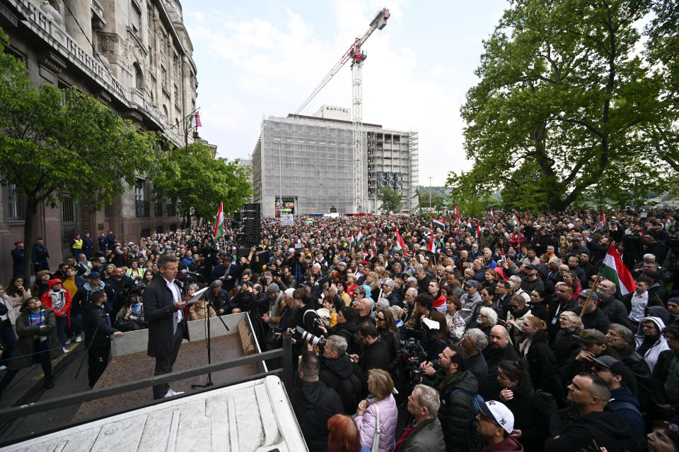 Peter Magyar, a former insider within Orban's ruling Fidesz party speaks during a protest outside the Hungarian Interior Ministry building to demand stronger protections for children and Interior minister Sandor Pinter to step down, in Budapest, Hungary, Friday, April 26, 2024. The demonstration was the latest in a series of large anti-government protests that Magyar has mobilized in recent weeks, and comes as the political newcomer is campaigning for EU elections this June with his new party, Respect and Freedom (TISZA). (AP Photo/Denes Erdos)