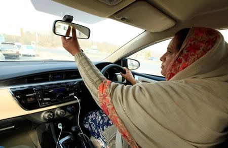 Yasmin Perveen, one of the pioneer women "captains" of Careem, adjusts back mirror while driving her car in Islamabad, Pakistan December 7, 2016. REUTERS/Faisal Mahmood