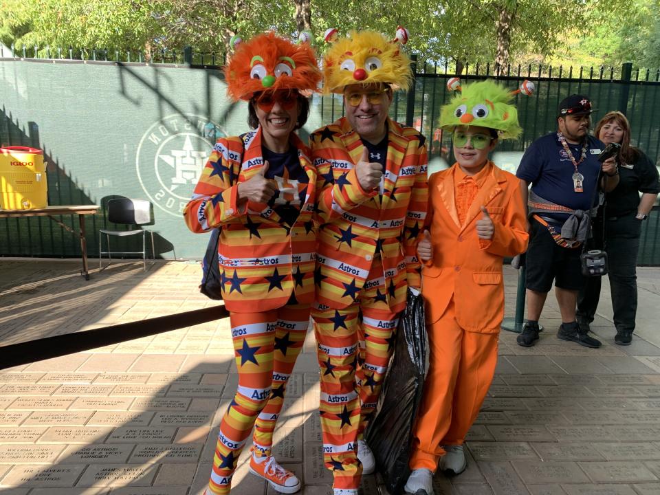 A family of Astros fans with their suits and custom-made hats. (Photo by Hannah Keyser.)