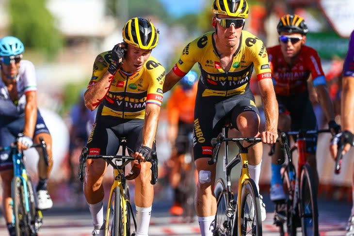 A bloodied Primoz Roglic crosses the finish line