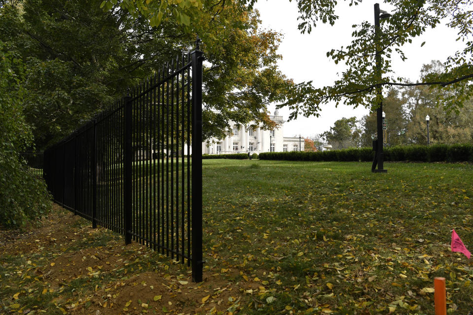 A security fence is being installed around the Governors Mansion on the grounds of the Kentucky State Capitol in Frankfort, Ky., Friday, Oct. 9, 2020. Security is being increased following a plot to kidnap the Governor of Michigan, and Andy Beshear, a Democrat, was hanged in effigy from a tree during a May protest against his COVID-19 restrictions on the state Capitol grounds in Frankfort. (AP Photo/Timothy D. Easley)