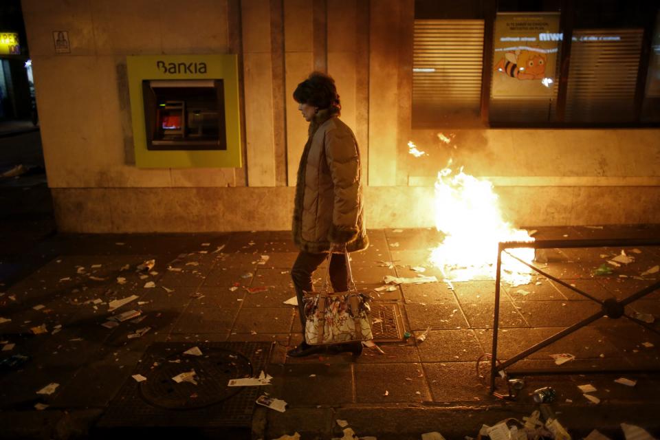 A woman passes by a Bankia bank branch during a protest in Madrid