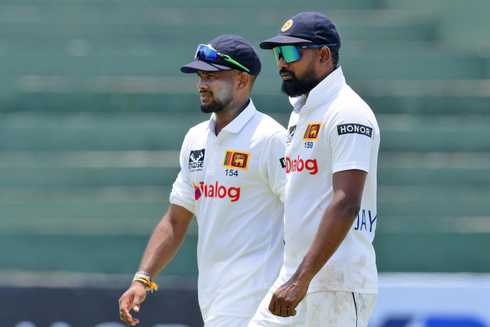 Sri Lanka's Ramesh Mendis, left, and teammate Prabath Jayasuriya leave the ground at the end of the New Zealand innings on the third day of the first cricket test match between New Zealand and Sri Lanka in Galle, Sri Lanka, Friday, Sept. 20, 2024. (AP Photo/Viraj Kothalawala)