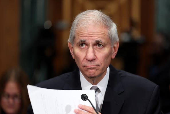 Martin Gruenberg holding a piece of paper.