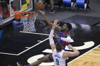 Detroit Pistons guard Josh Jackson (20) goes up for a shot in front of Orlando Magic center Nikola Vucevic (9) during the second half of an NBA basketball game, Tuesday, Feb. 23, 2021, in Orlando, Fla. (AP Photo/Phelan M. Ebenhack)