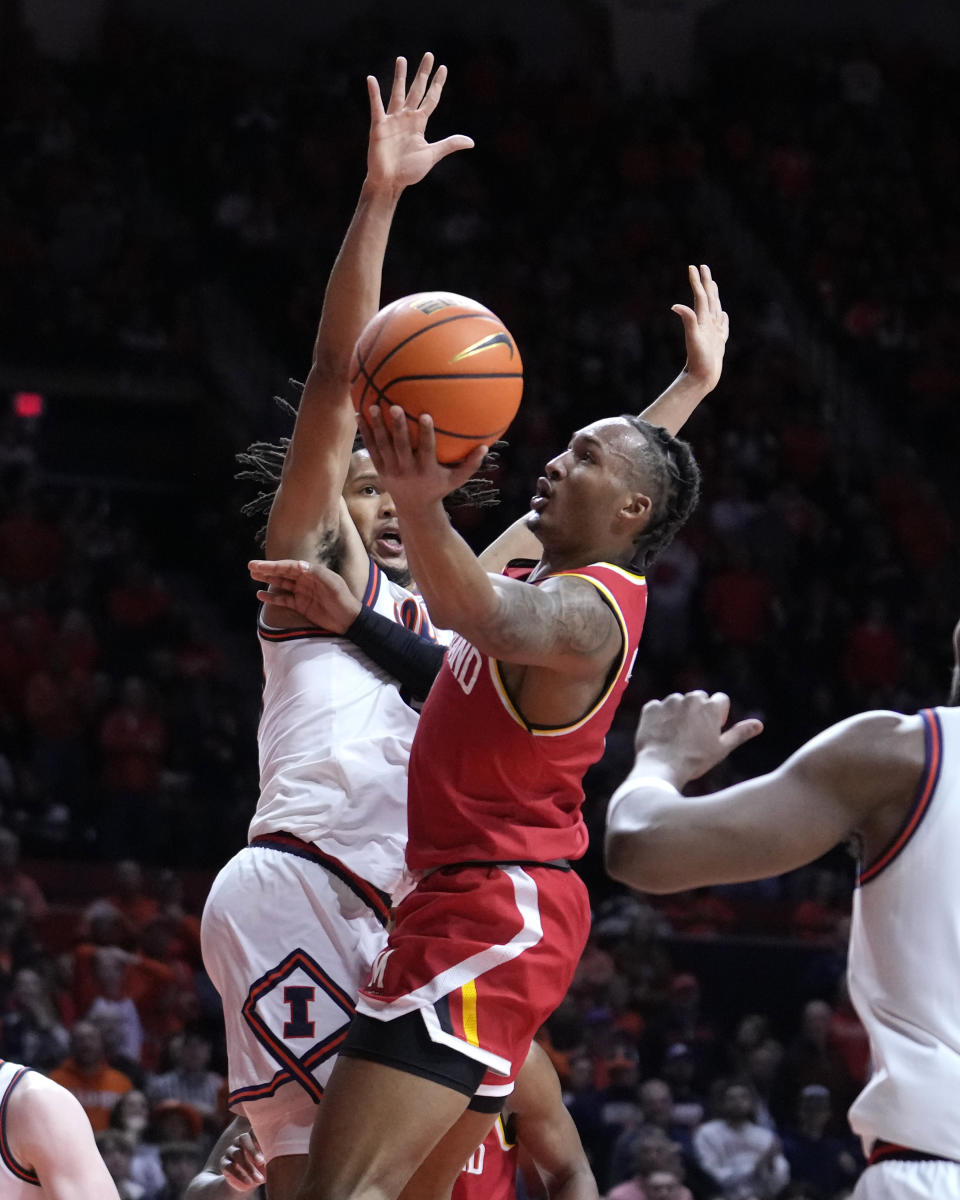 Maryland's Jahmir Young, drives to the basket as Illinois' Ty Rodgers defends during the second half of an NCAA college basketball game Sunday, Jan. 14, 2024, in Champaign, Ill. Maryland upset Illinois 76-67. (AP Photo/Charles Rex Arbogast)