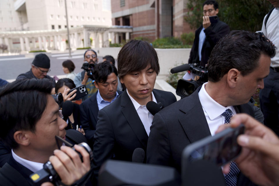 Ippei Mizuhara, center, the former longtime interpreter for the Los Angeles Dodgers baseball star Shohei Ohtani, leaves federal court following his arraignment, Tuesday, May 14, 2024, in Los Angeles. Mizuhara pleaded not guilty Tuesday to bank and tax fraud, a formality ahead of a plea deal he’s negotiated with federal prosecutors in a wide-ranging sports betting case. (AP Photo/Eric Thayer)