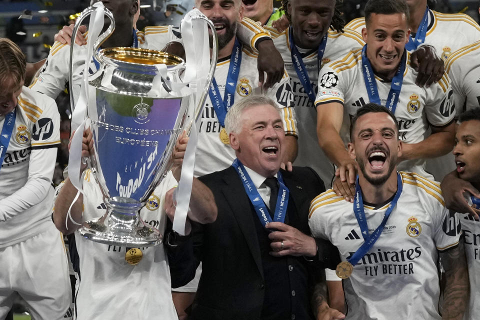 Real Madrid's head coach Carlo Ancelotti celebrates with the players after winning the Champions League final match over Borussia Dortmund at Wembley stadium in London on Saturday. (AP Photo/Frank Augstein)