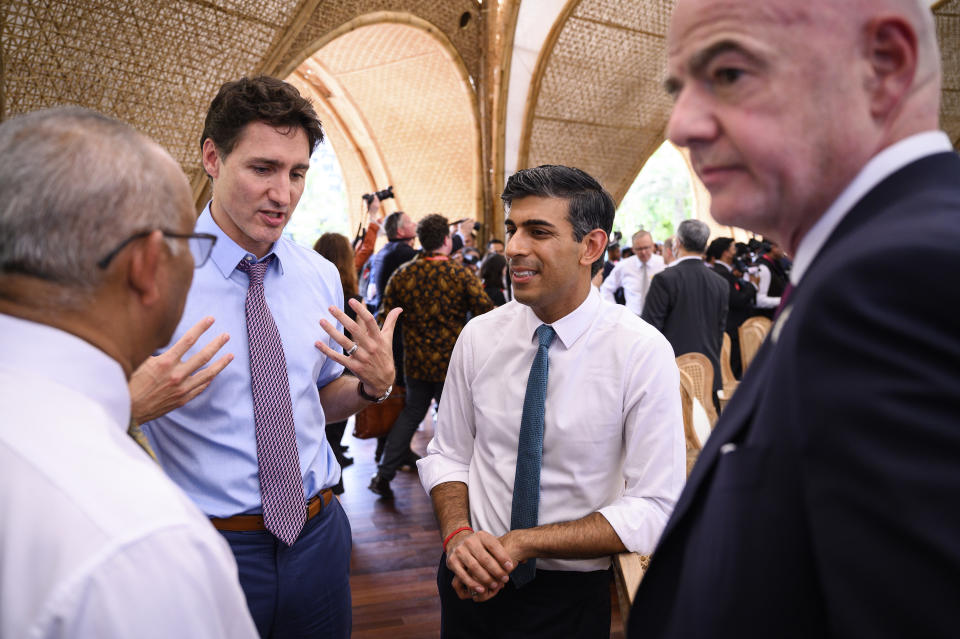 Canadian Prime Minister Justin Trudeau, second left, Britain's Prime Minister Rishi Sunak, second right, and FIFA President Gianni Infantino, right, chat ahead of a working lunch at the G20 Summit, Tuesday, Nov. 15, 2022 in Nusa Dua, Bali, Indonesia. (Leon Neal/Pool Photo via AP)